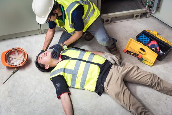Construction worker doing CPR